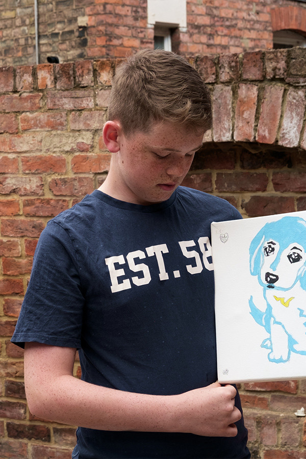 Child with painting of a dog