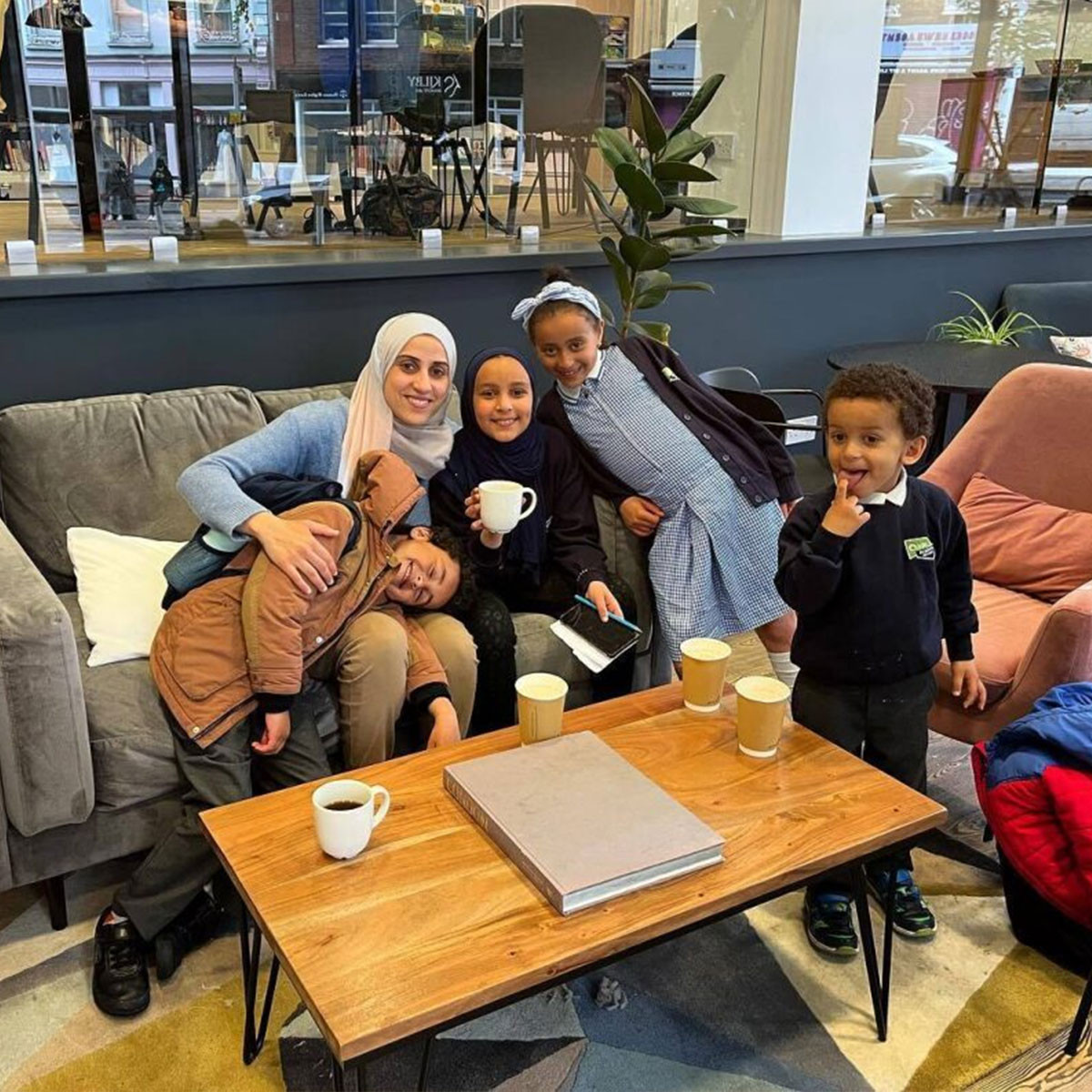 Parent with four children in a cafe